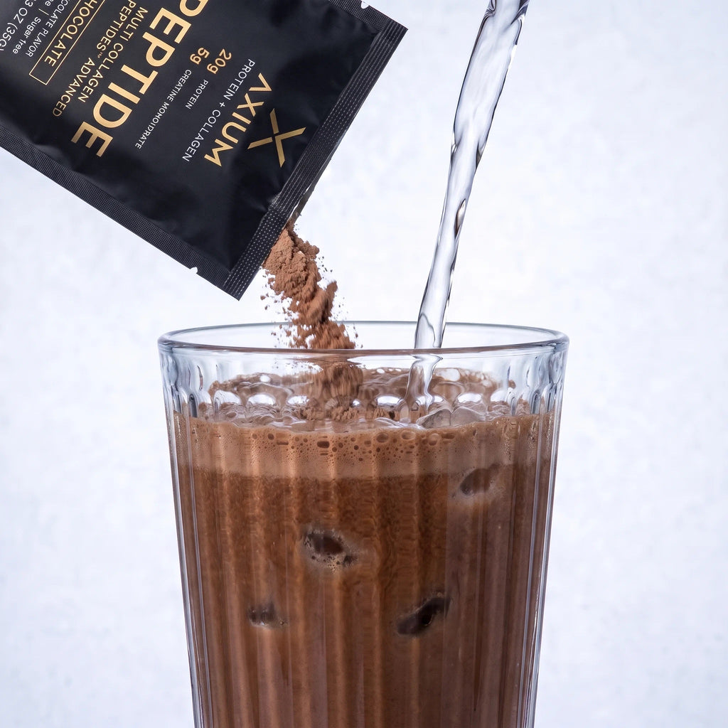 Chocolate Axium Athletics powder poured into a glass of water