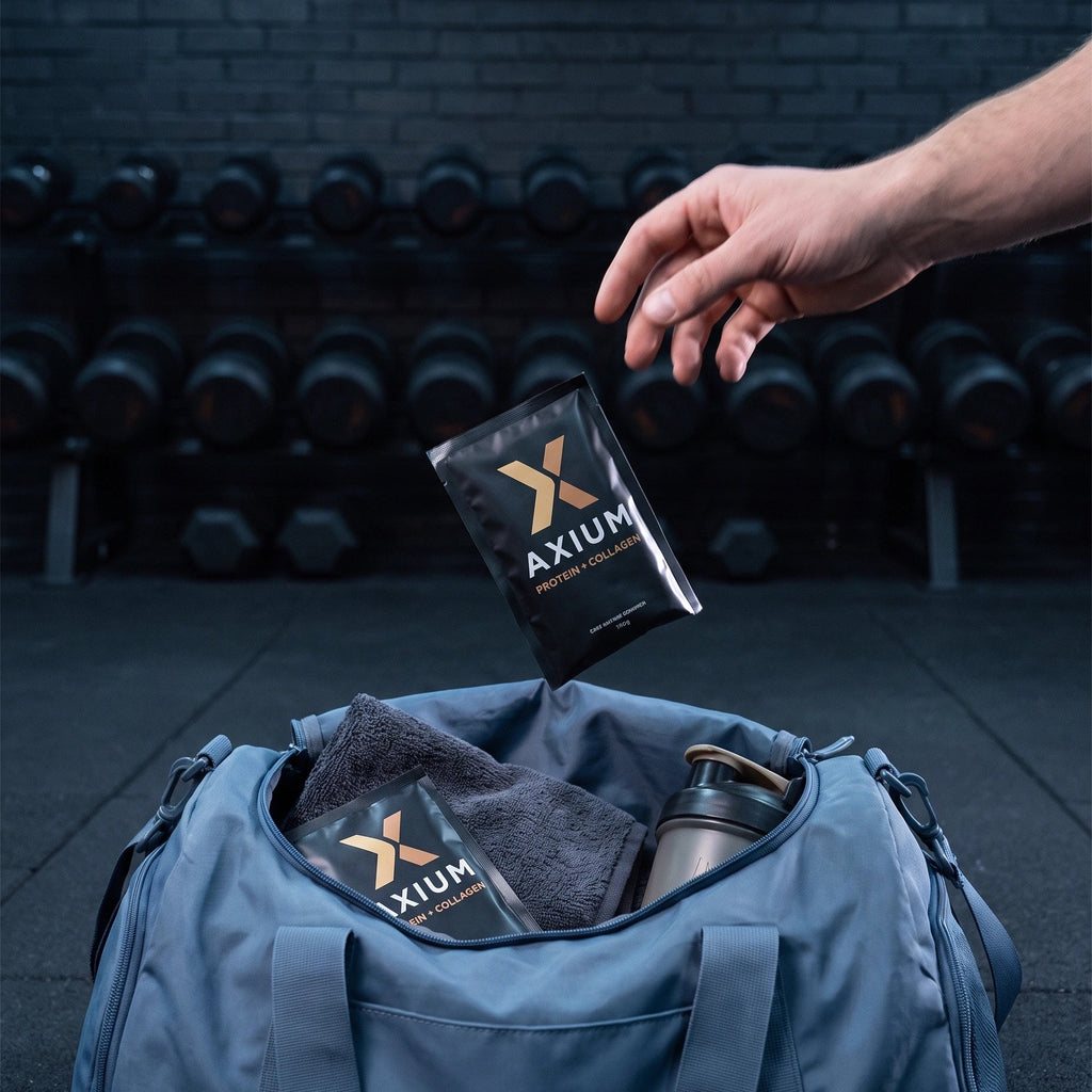 An Axium Athletics sachet dropped into a gym bag — the stack goes where you go